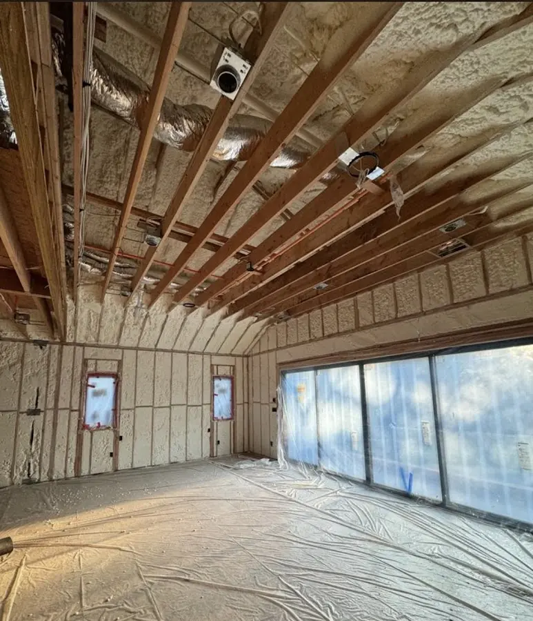 Interior walls and ceiling insulated with spray foam during new construction in Lynn